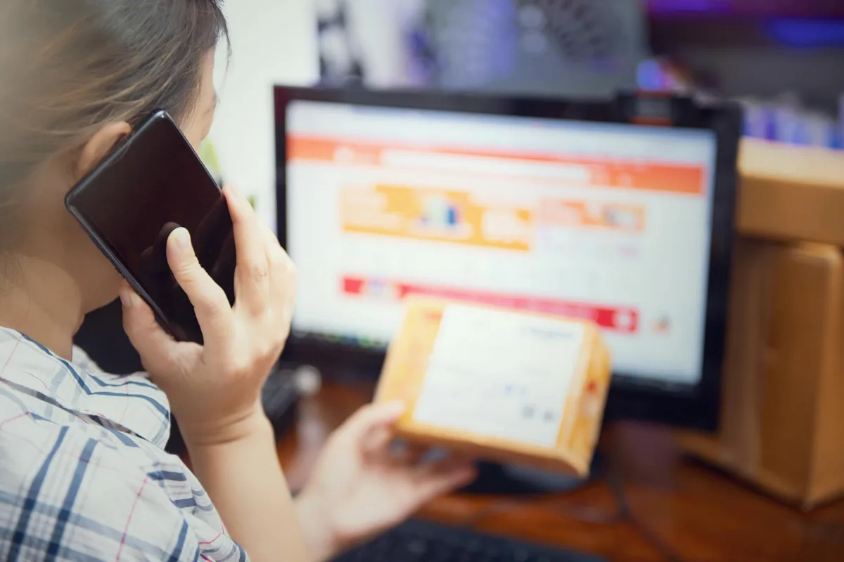 Woman using smartphone to browse and shop online, representing Malaysian ecommerce consumer