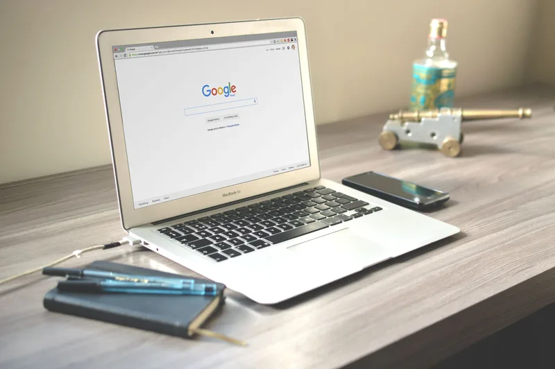 Woman managing her online business from home office with laptop and product inventory