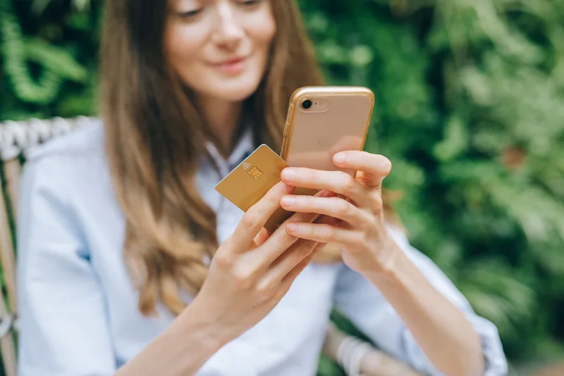Woman using smartphone at cafe browsing Instagram in Malaysia
